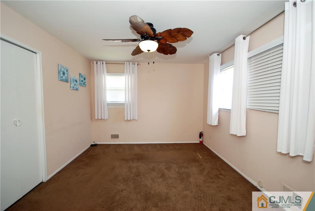 25 Barlow Road Edison, NJ 08817 - Photo 15 of 27 a view of empty room with wooden floor and fan