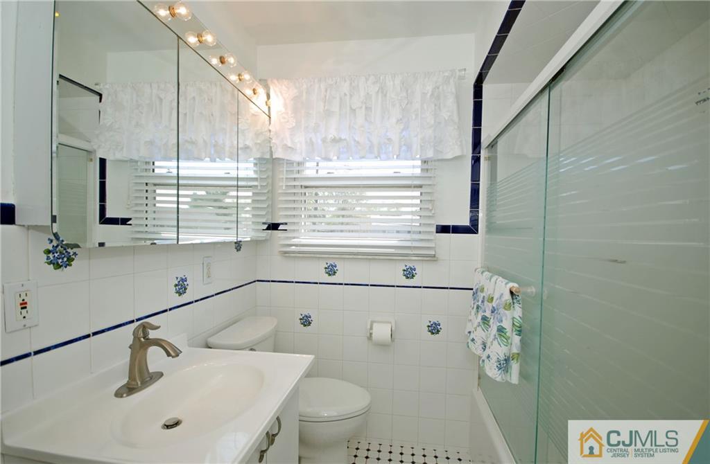 25 Barlow Road Edison, NJ 08817 - Photo 17 of 27 a bathroom with a sink a toilet and a mirror