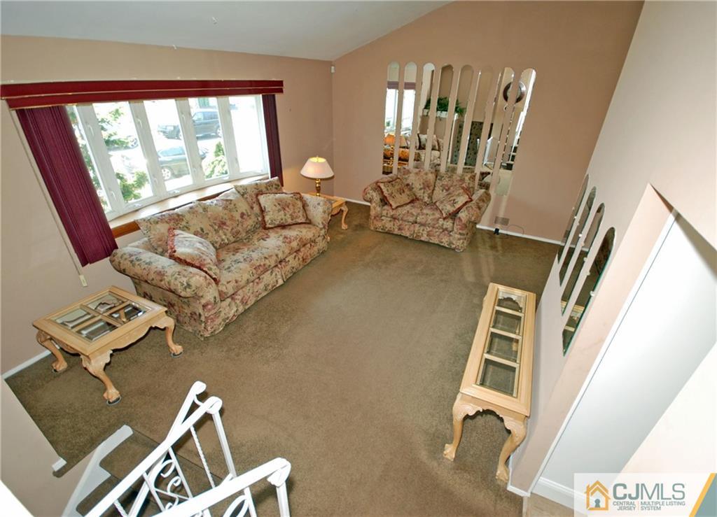 25 Barlow Road Edison, NJ 08817 - Photo 4 of 27 a living room with couches and a flat screen tv
