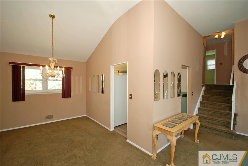 25 Barlow Road Edison, NJ 08817 - Photo 6 of 27 a view of a livingroom with furniture and stairs