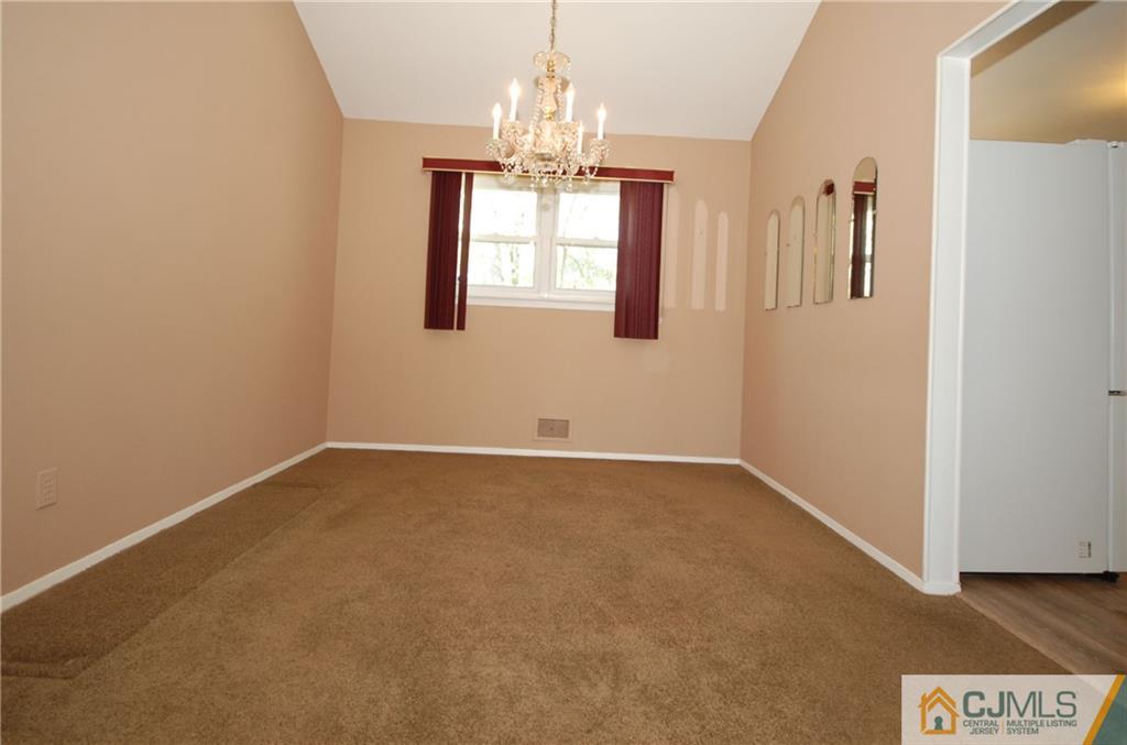 25 Barlow Road Edison, NJ 08817 - Photo 7 of 27 a view of a hallway with a chandelier