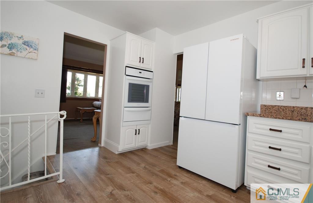 25 Barlow Road Edison, NJ 08817 - Photo 9 of 27 a white refrigerator freezer and a stove sitting inside of a kitchen