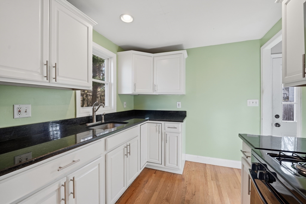 30 Lively Lane Springfield, MA 01109 - Photo 5 of 33 a kitchen with granite countertop a sink a stove and cabinets