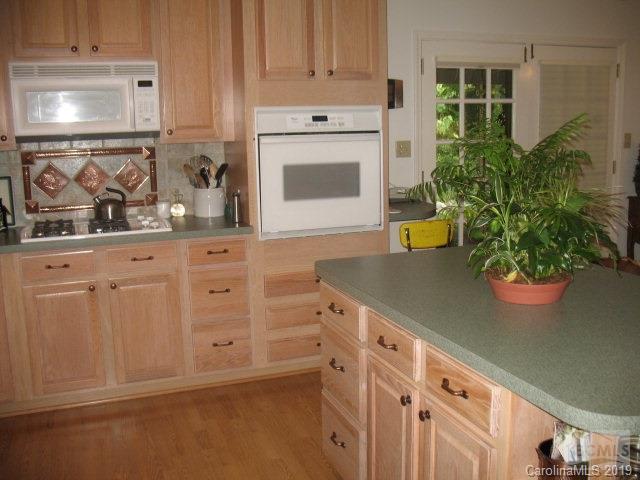 103 Ervindale Lane Morganton, NC 28655 - Photo 8 of 13 a kitchen with white cabinets and a stove