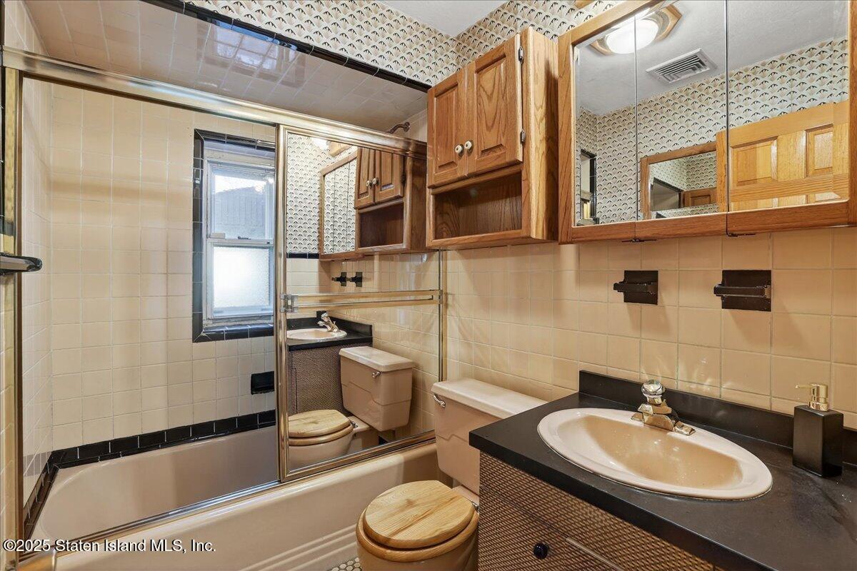 35 Crowell Avenue Staten Island, NY 10314 - Photo 15 of 33 a bathroom with a granite countertop sink and a mirror