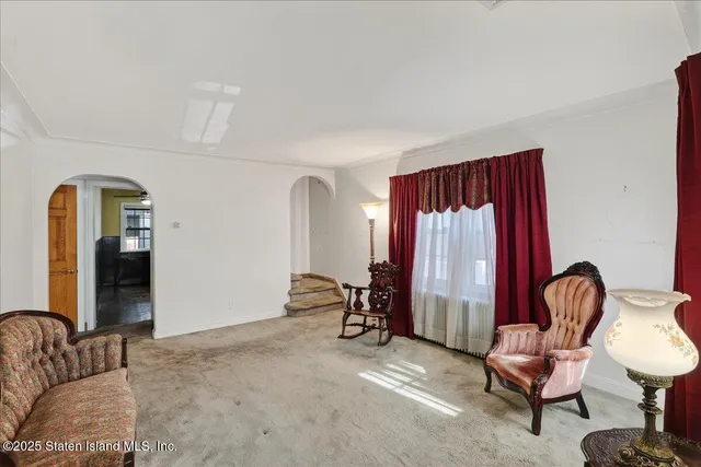 a living room with furniture and a chair