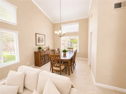 a dining room with furniture and window