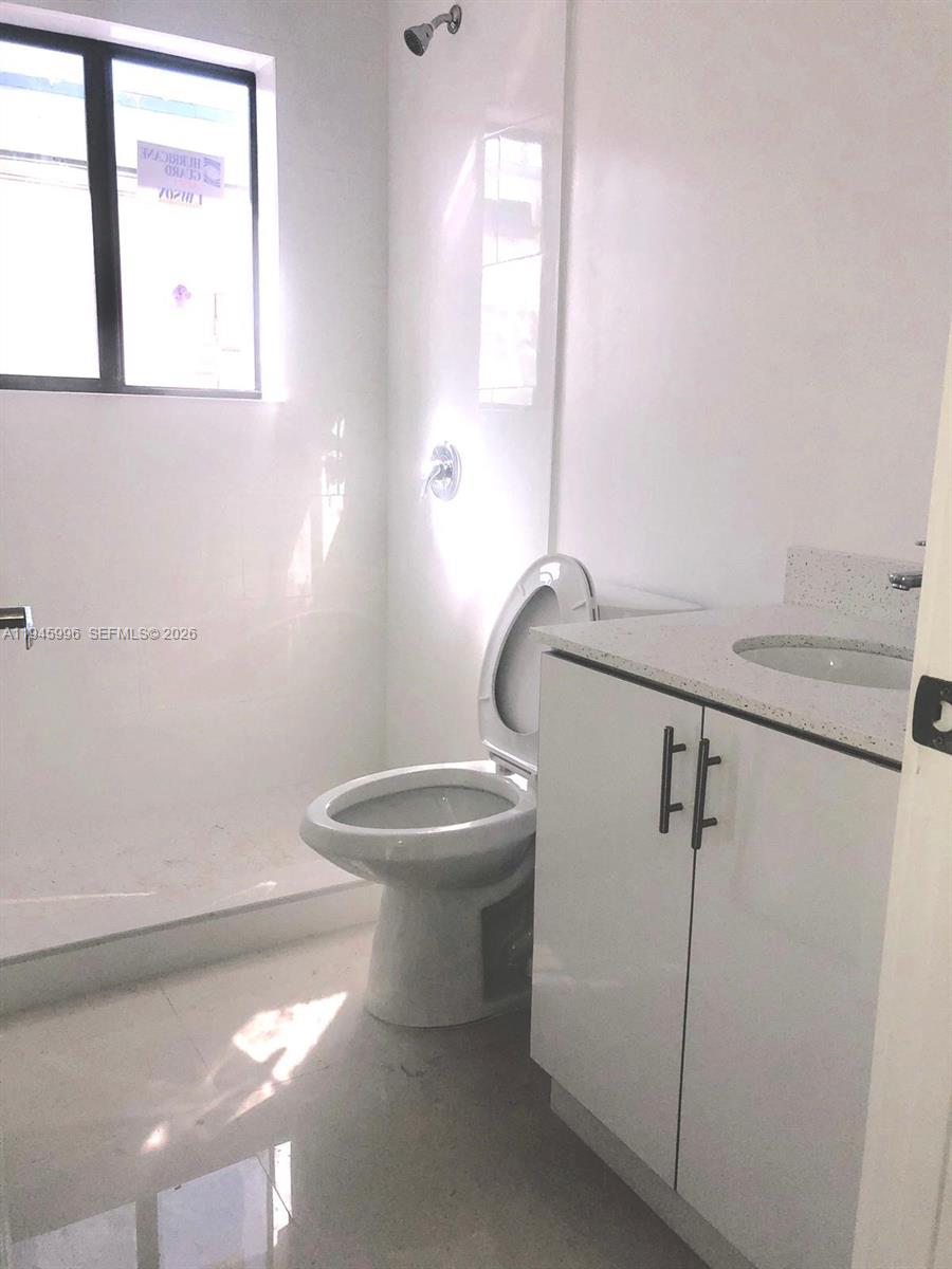 660 82nd Street, Unit 4 Miami Beach, FL 33141 - Photo 8 of 11 a bathroom with a toilet and a sink