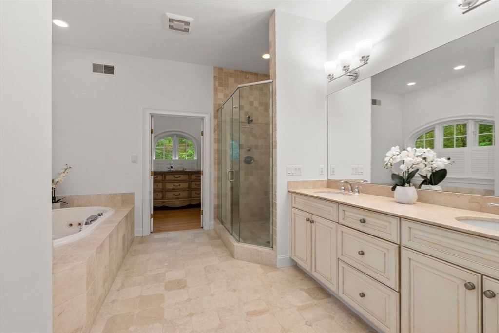 20 Flint Road Concord, MA 01742 - Photo 13 of 34 a spacious bathroom with a double vanity sink a large mirror a shower and bathtub