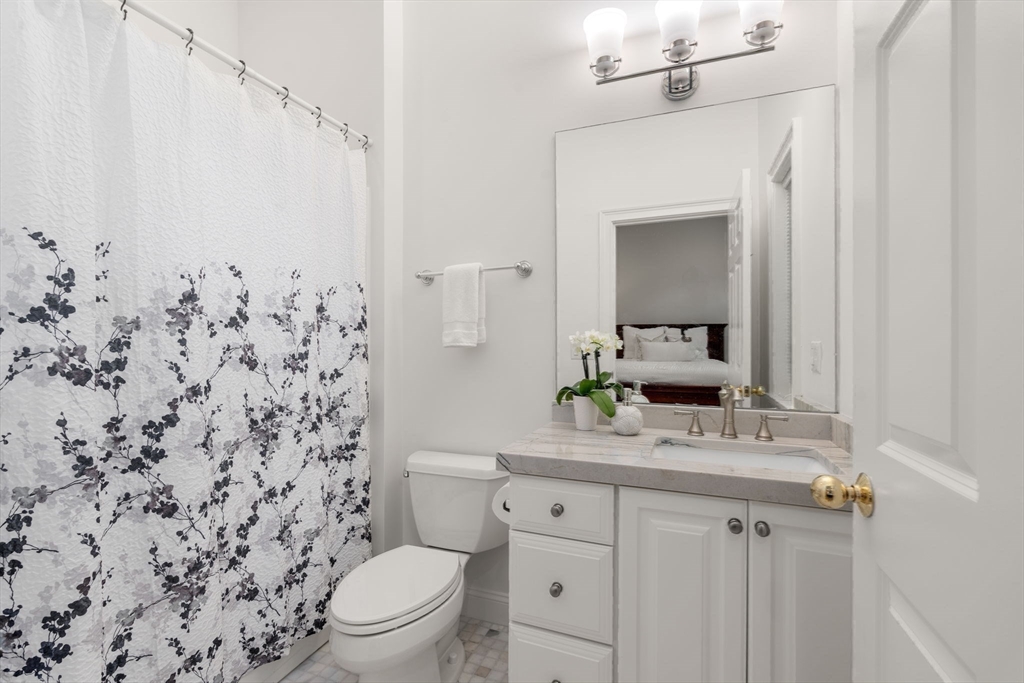 20 Flint Road Concord, MA 01742 - Photo 15 of 34 a bathroom with a granite countertop sink toilet mirror and shower