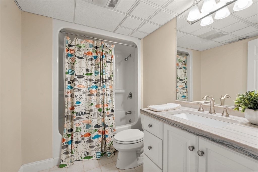20 Flint Road Concord, MA 01742 - Photo 27 of 34 a bathroom with a sink a toilet and shower curtain