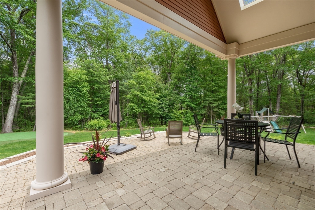 20 Flint Road Concord, MA 01742 - Photo 29 of 34 a view of a patio with a table chairs and a backyard