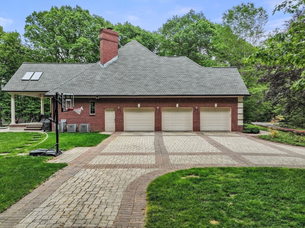 20 Flint Road Concord, MA 01742 - Photo 31 of 34 a front view of a house with a yard and garage