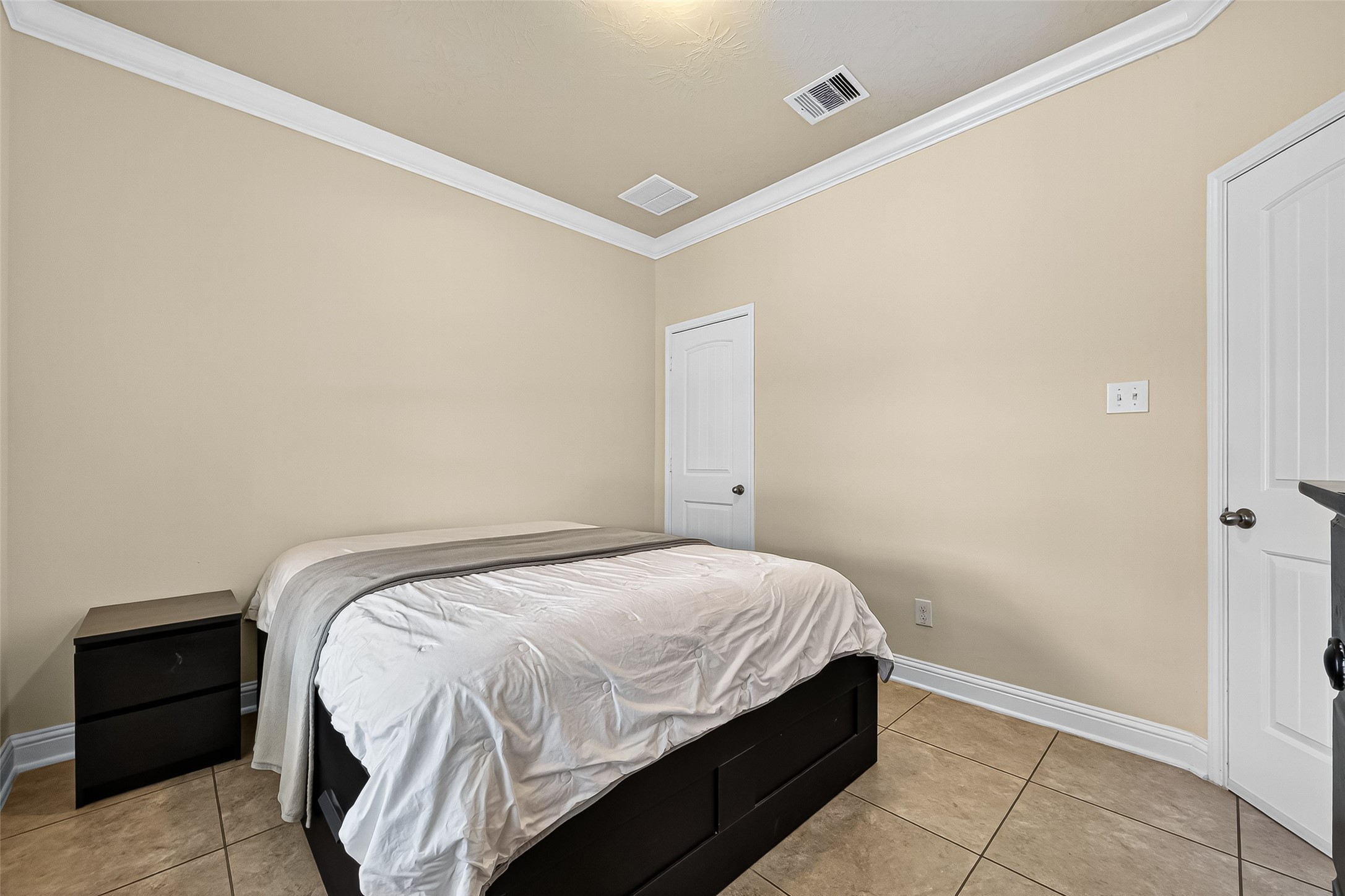 8107 Lockridge Terrace Lane Cypress, TX 77433 - Photo 25 of 50 Here’s an alternate view of the downstairs bedroom, highlighting the spacious layout and neutral tones that make it a calm, inviting retreat. The closet and nearby full bathroom add functionality, making it ideal for guests, in-laws, or even a private office.