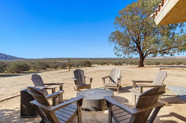 a view of a terrace with chairs and a fire pit