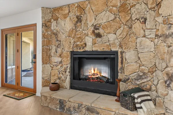 a living room with a fireplace and a flat screen tv