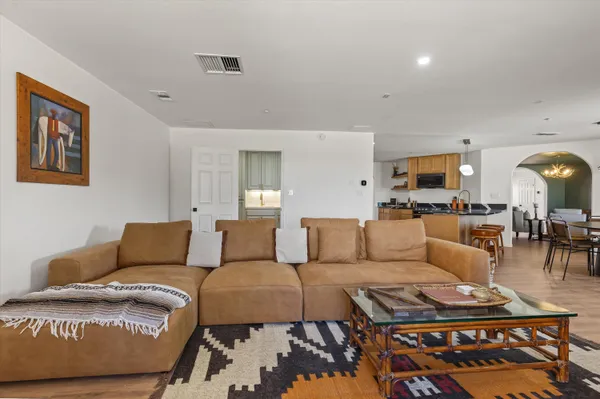 a living room with furniture and wooden floor