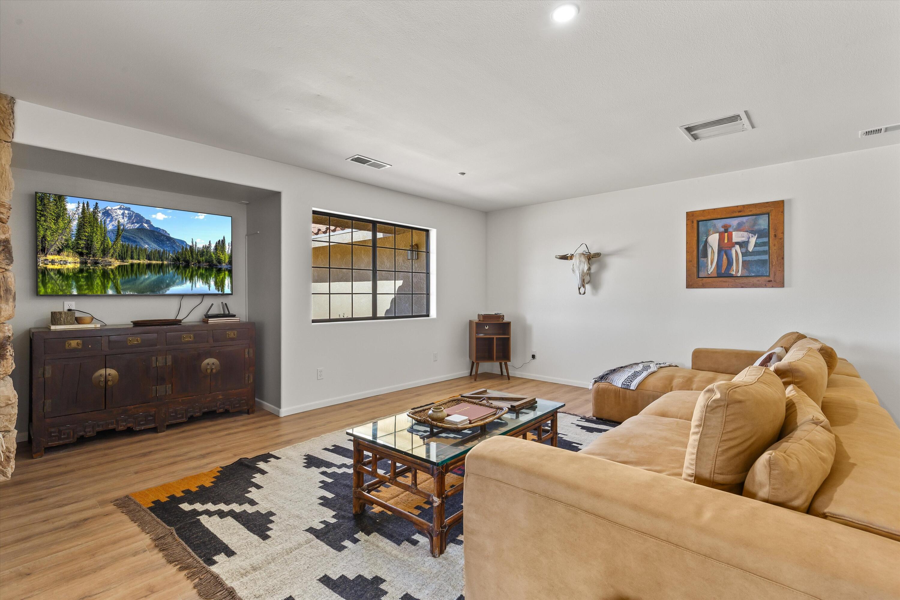 62850 Dennis Avenue Joshua Tree, CA 92252 - Photo 15 of 39 a living room with furniture and a flat screen tv