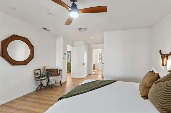 a bedroom with a bed and a chandelier