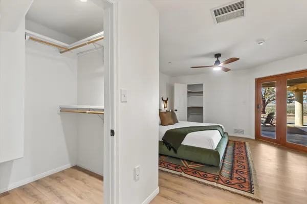 a view of a bedroom with furniture and wooden floor