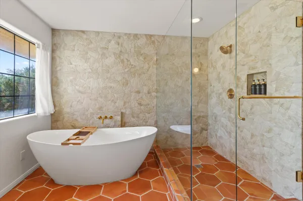 a bathroom with a bathtub and shower