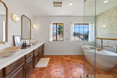 a bathroom with a double vanity sink and a mirror