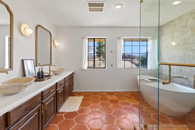 a bathroom with a double vanity sink and a mirror