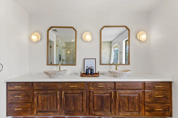 a bathroom with a double vanity sink and a mirror