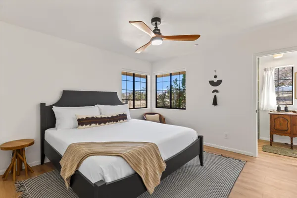 a bedroom with a large bed and a chandelier