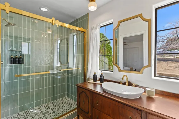 a bathroom with a double vanity sink and a large mirror