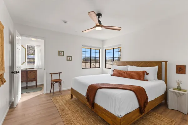 a bedroom with a bed and wooden floor