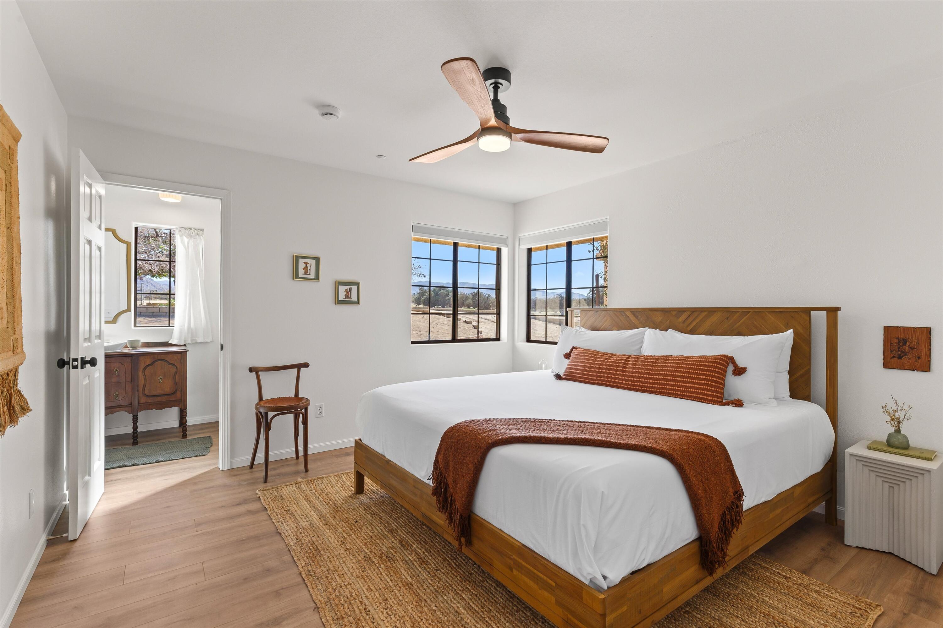 62850 Dennis Avenue Joshua Tree, CA 92252 - Photo 25 of 39 a bedroom with a bed and wooden floor