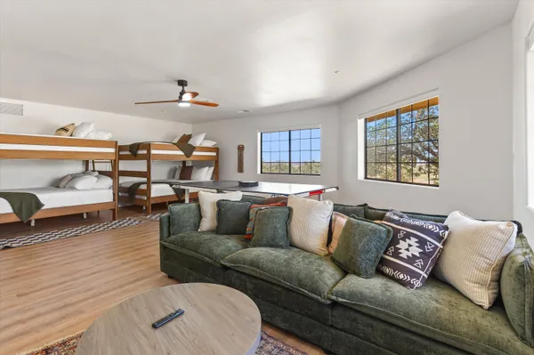 a living room with furniture and a wooden floor