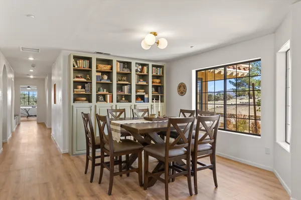 a view of a dining room with furniture and window