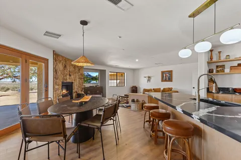 a kitchen with a dining table and chairs