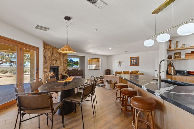 a kitchen with a dining table and chairs