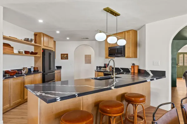 a kitchen with a dining table and chairs