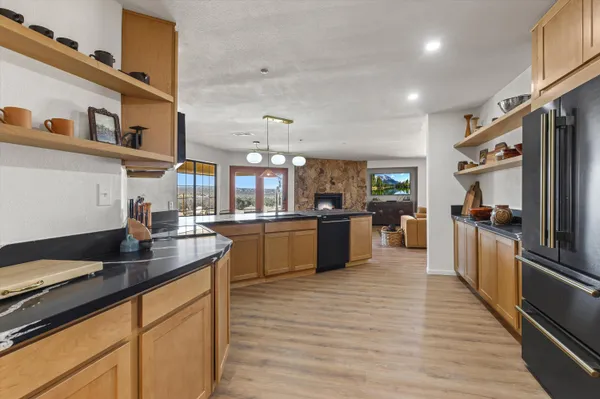 a kitchen with stainless steel appliances granite countertop a sink counter space and cabinets