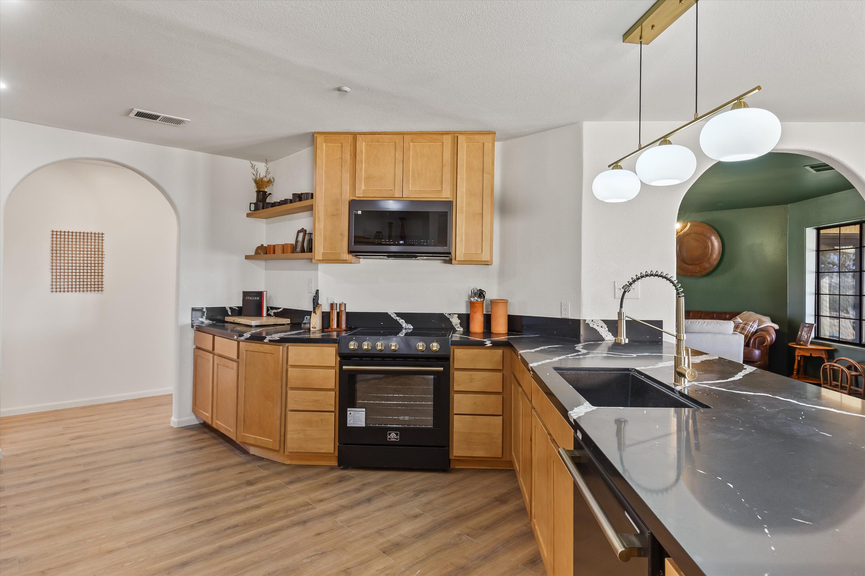 62850 Dennis Avenue Joshua Tree, CA 92252 - Photo 9 of 39 a kitchen with stainless steel appliances granite countertop a sink and a stove