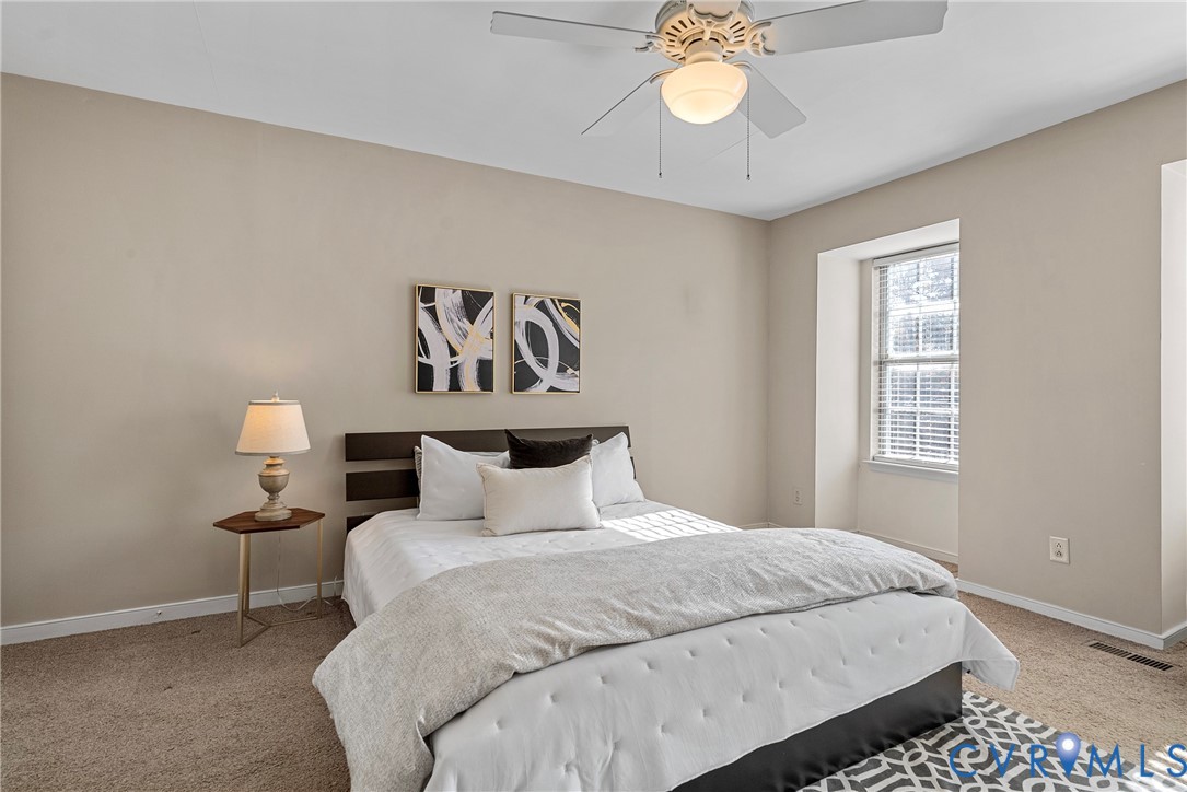 11612 Timberly Waye Henrico, VA 23238 - Photo 13 of 37 a bedroom with a bed and a chandelier