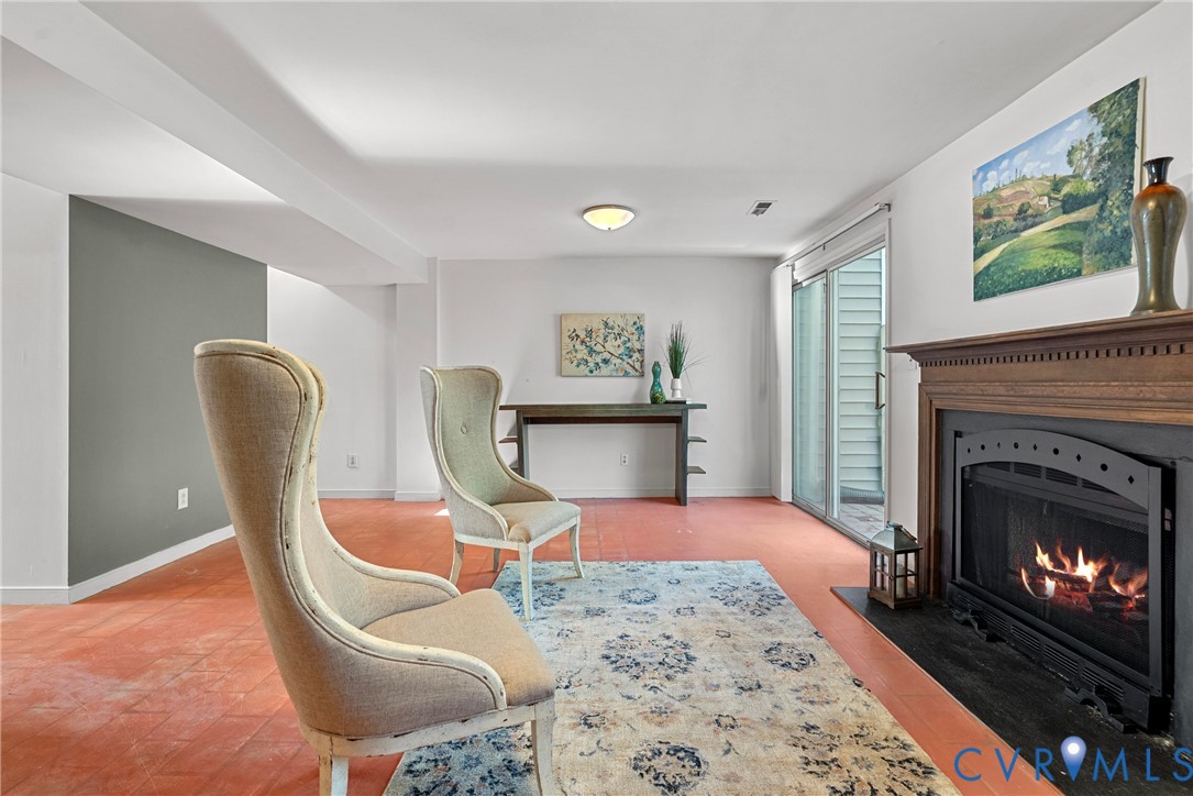 11612 Timberly Waye Henrico, VA 23238 - Photo 21 of 37 a living room with furniture a flat screen tv and a fireplace