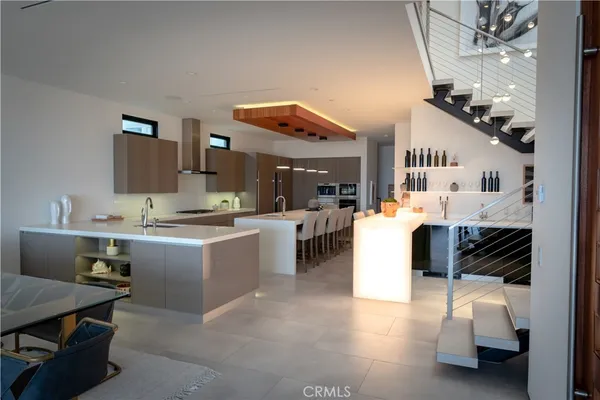 a kitchen with a sink and living room view