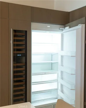 a view of walk in closet with empty racks