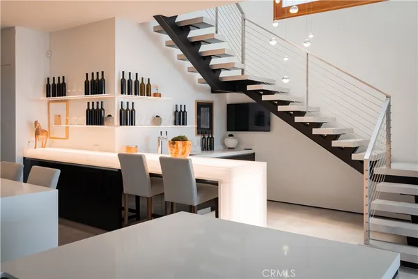 a kitchen with a table chairs a stove and a dining table