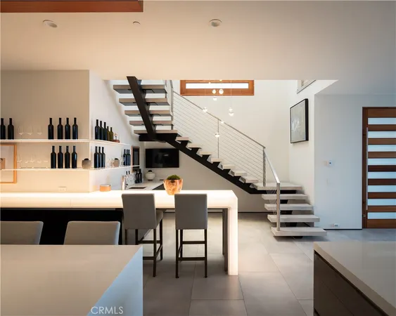 a living room with furniture and stairs