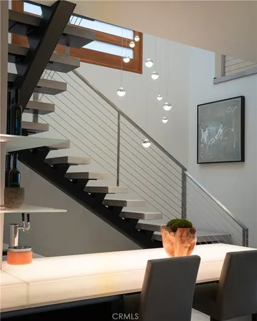 a dining room with furniture and stairs