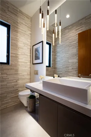 a bathroom with a sink a toilet and mirror