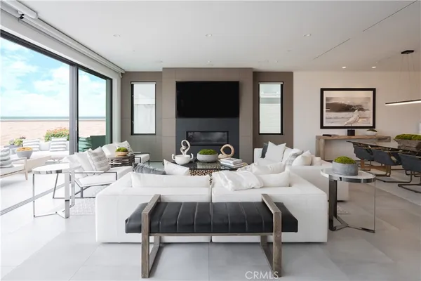 a living room with furniture a flat screen tv and a large window