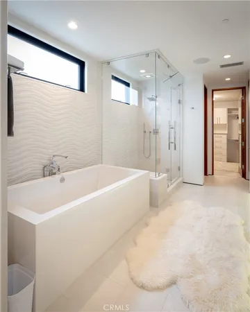 a bathroom with a bathtub and a shower