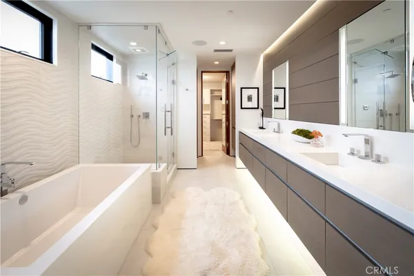 a spacious bathroom with a tub sink shower and mirror